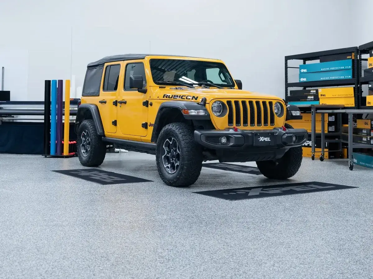 Yellow Jeep Rubicon in the Autograff studio with XPEL film racks, North Hollywood